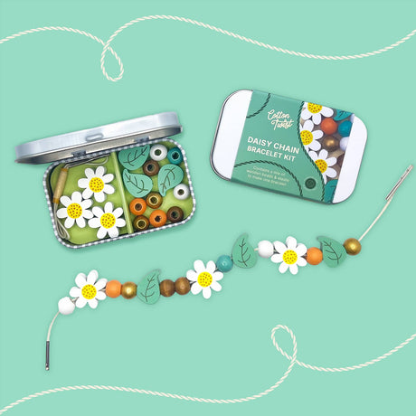 Daisy chain bracelet kit with open tin, beads, and a completed bracelet on a teal background.