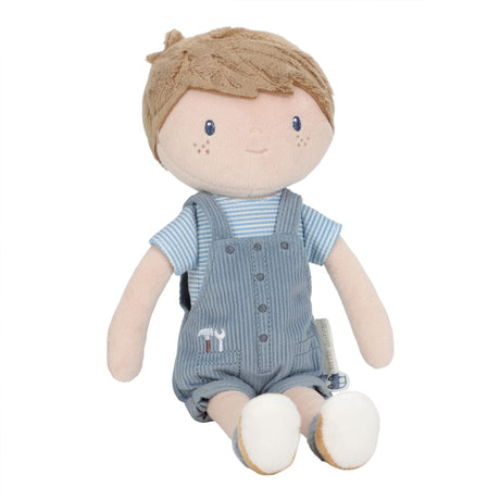 Soft boy doll with stiched face in blue overalls, a stripey blue t-shirt, blue socks and brown shoes. Embroidered tools in his pocket