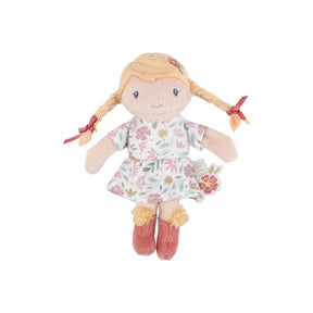 Soft mini doll with blonde pigtails and a floral dress on a white background