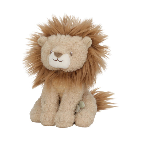 A soft lion toy with a fluffy tan and cream body, a golden-brown mane, and a small green tag on its side, photographed against a plain white background.