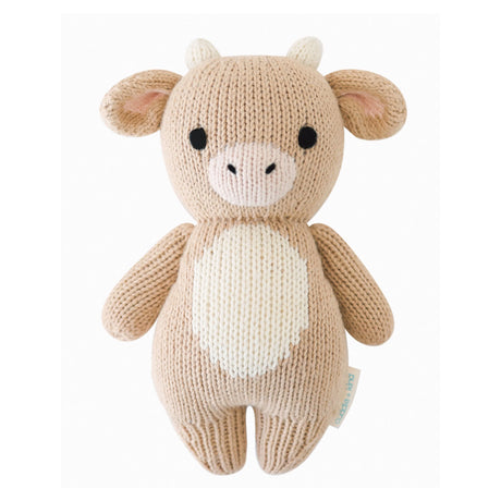 Hand knitted toy Jersey cow on a white background