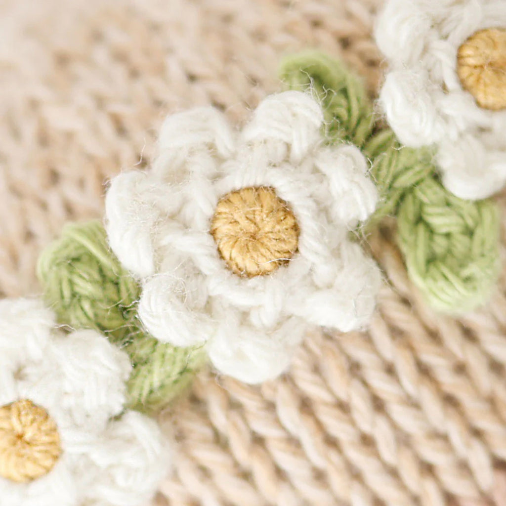 Close-up of white crocheted flowers with gold centers 