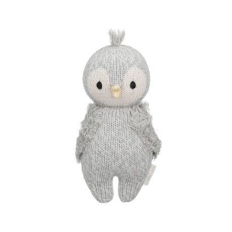 Handknitted baby penguin soft toy on a white background