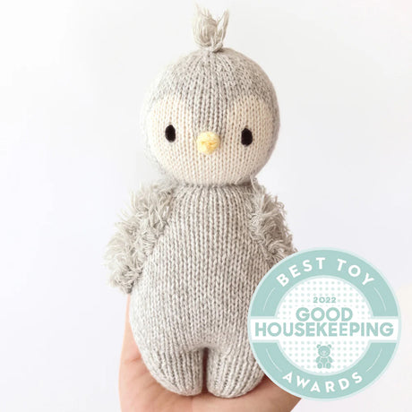 Knitted Baby Penguin toy with a 'Best Toy' Good Housekeeping Award badge on a white background
