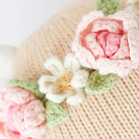 Close-up of a knitted flower decoration on a textured surface