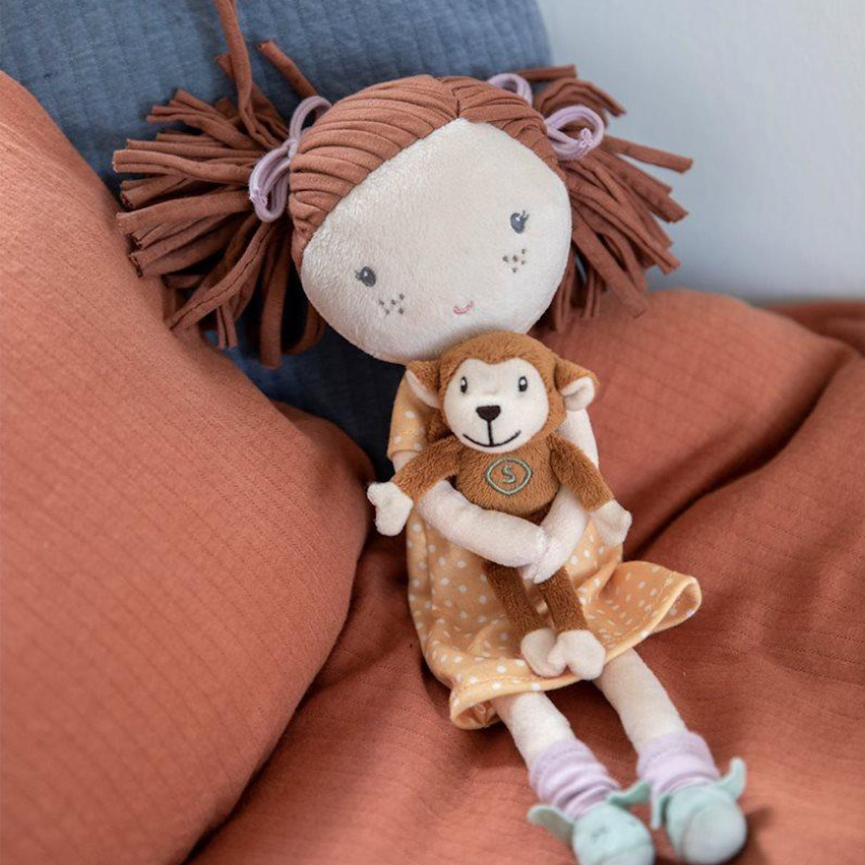 Close-up of Sophia plush doll showing soft fabric details and embroidered features