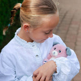 Young girl cuddling the Cutydoos Pink Dog soft toy by Rainbow Designs