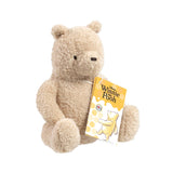 Disney Winnie the Pooh 100 curly plush bear sitting with Rainbow Designs gift tag, side angle on white background