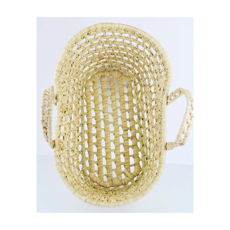 A beige wicker bassinet or moses basket with two side handles, suitable for carrying dolls or soft toys.