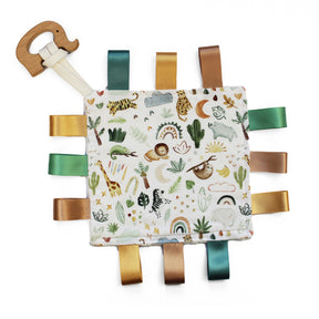 Baby comfort blanket with animals and plants, ribbon tags in browns and greens and wooden elephent teether attached
