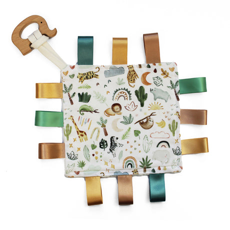 Baby comfort blanket with animals and plants, ribbon tags in browns and greens and wooden elephent teether attached