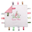 A personalised ribbon taggy blanket with a Flopsy bunny design, featuring a white or cream background with pink / green ribbon tags. The blanket has a Dimple Minky back in pink, white, cream  green or and includes decorative satin  tags with a variety of patterns.