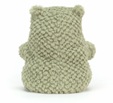 A plush toy resembling a green frog with a happy facial expression, made from a soft, textured fabric.