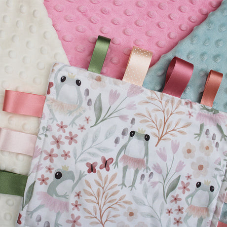 Fabric swatches with floral patterns and ribbons on a textured surface