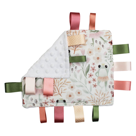 Handmade Baby comfort blanket with ballet frog design, colourful ribbons and a flower baby rattle on a white background