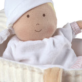 Soft baby doll in carry cot