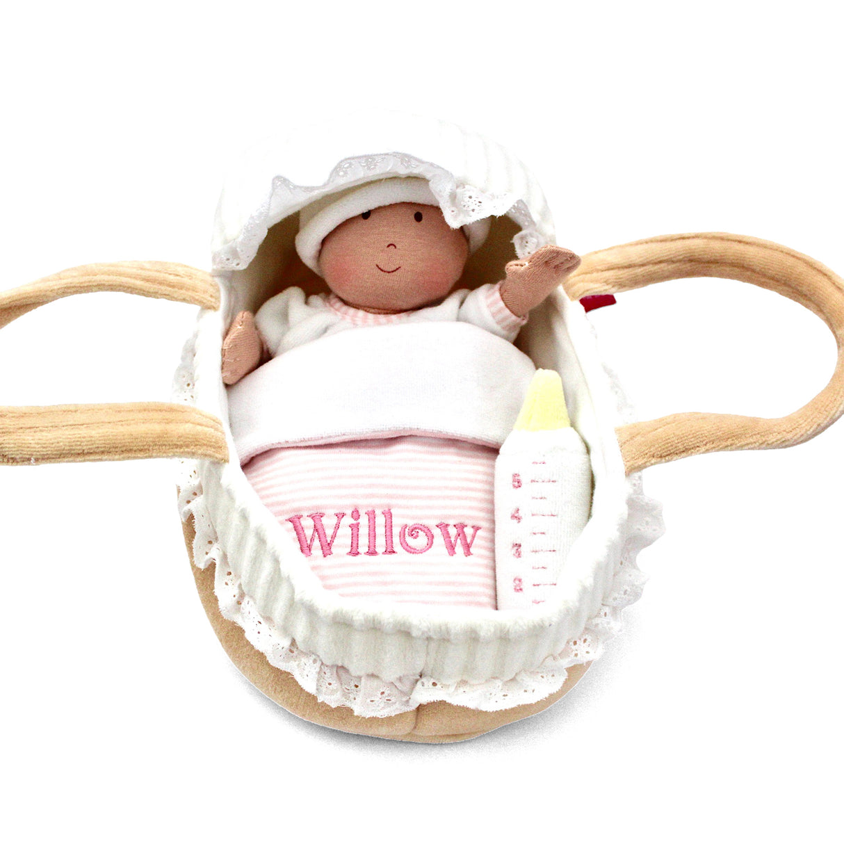 Soft baby doll in a basket with personalised name on blanket on a white background