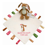 Baby comfort blanket with embroidered text and soft rattle toy rabbit on a white background