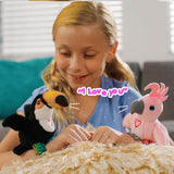 A young girl with two chirping wrist bird toys, a black and yellow toucan and a pink cockatoo. A pink speech bubble says 'I Love you'.