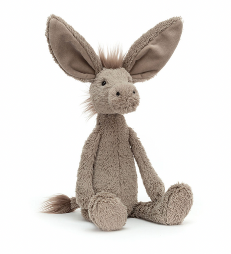 A soft gray fabric donkey toy with a spiky mane and long flappy ears, sitting upright.