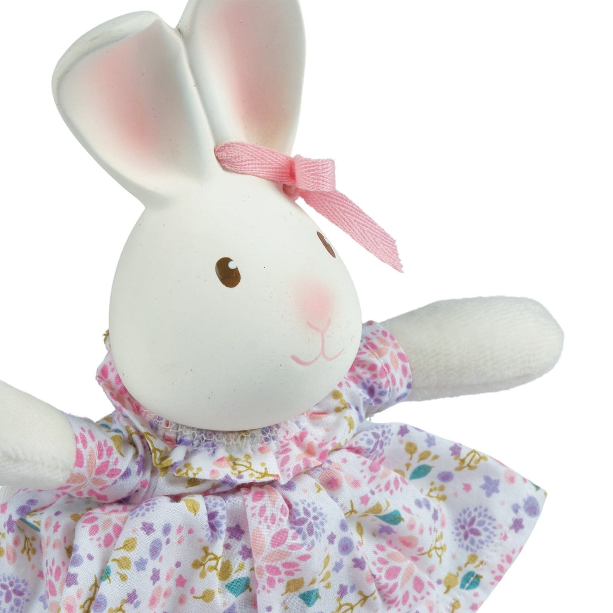 White rubber bunny toy with a pink bow and floral dress on a white background