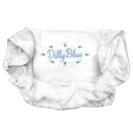 White blanket with personalised embroiderd name with blue flowers on a white background
