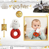 Harry Potter sensory play toy with a baby holding it, featuring a castle and owl in the background.