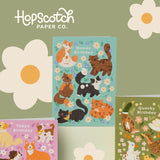 Birthday Card with turquoise background 6 different colourd brown black cats and flowers on a green background with two other birthday cards