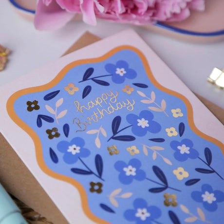 Close up of Hopscotch Paper Co. blue floral Happy Birthday card showing gold foil detail and botanical flower pattern
