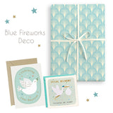 Packaging with blue fireworks design, cards, and envelopes on a white background
