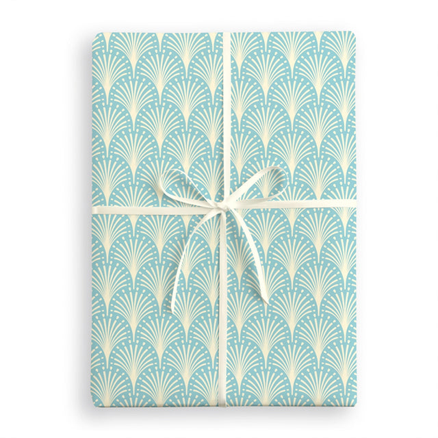 Gift wrap with a blue and white geometric pattern and a white ribbon on a white background