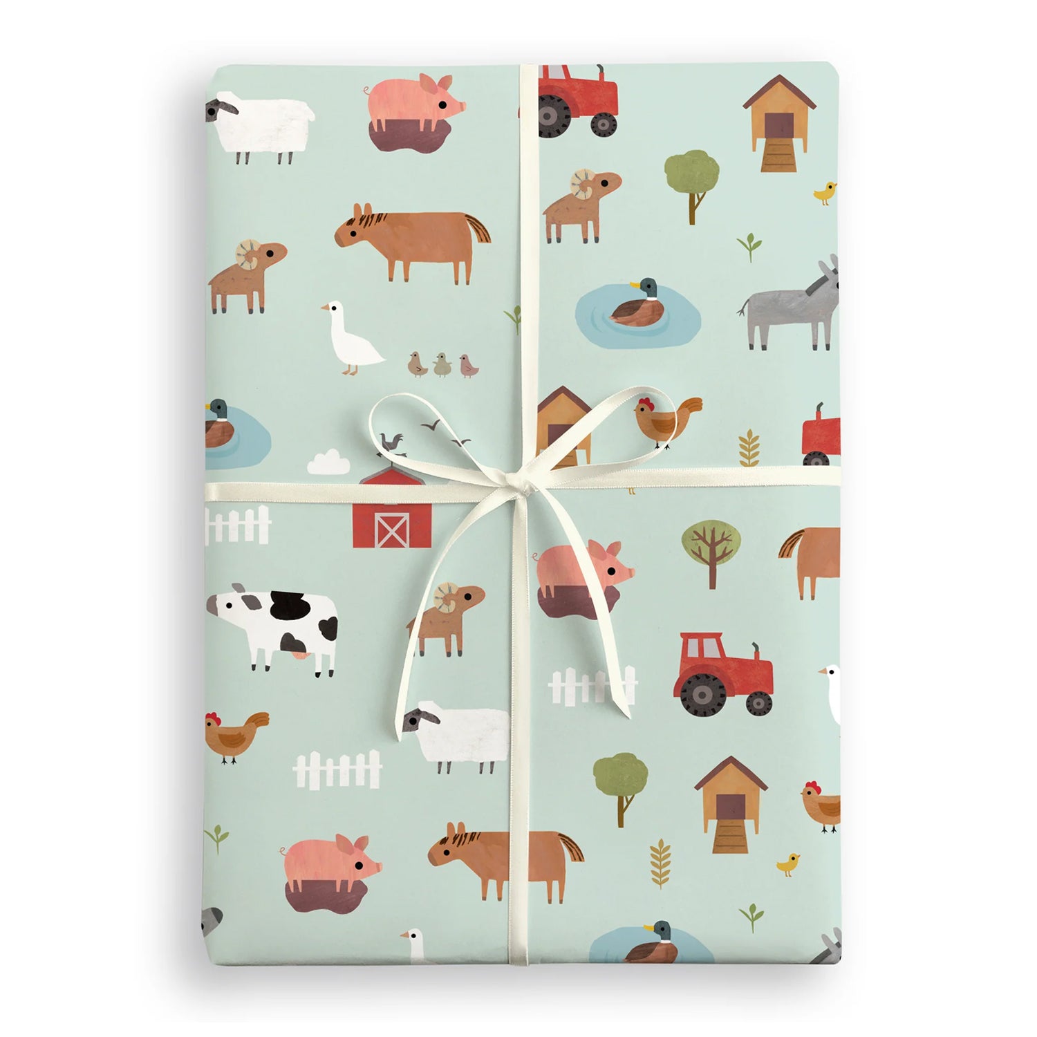 Gift wrapped in farm-themed paper with a white ribbon on a white background