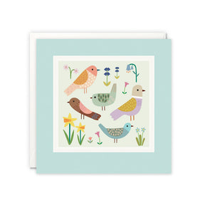 Greeting card with colourful birds and flowers on a light blue background