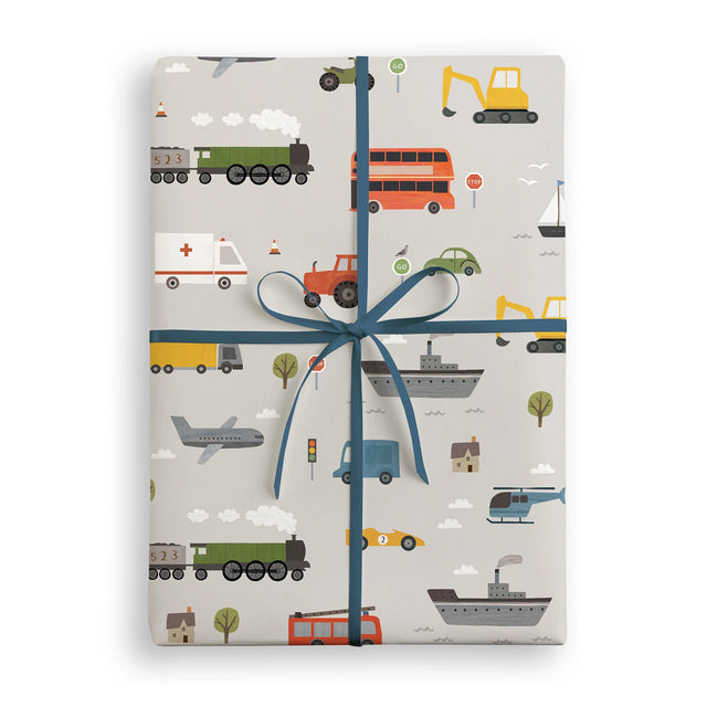 Gift wrapped in paper with vehicle pattern and blue ribbon on a white background