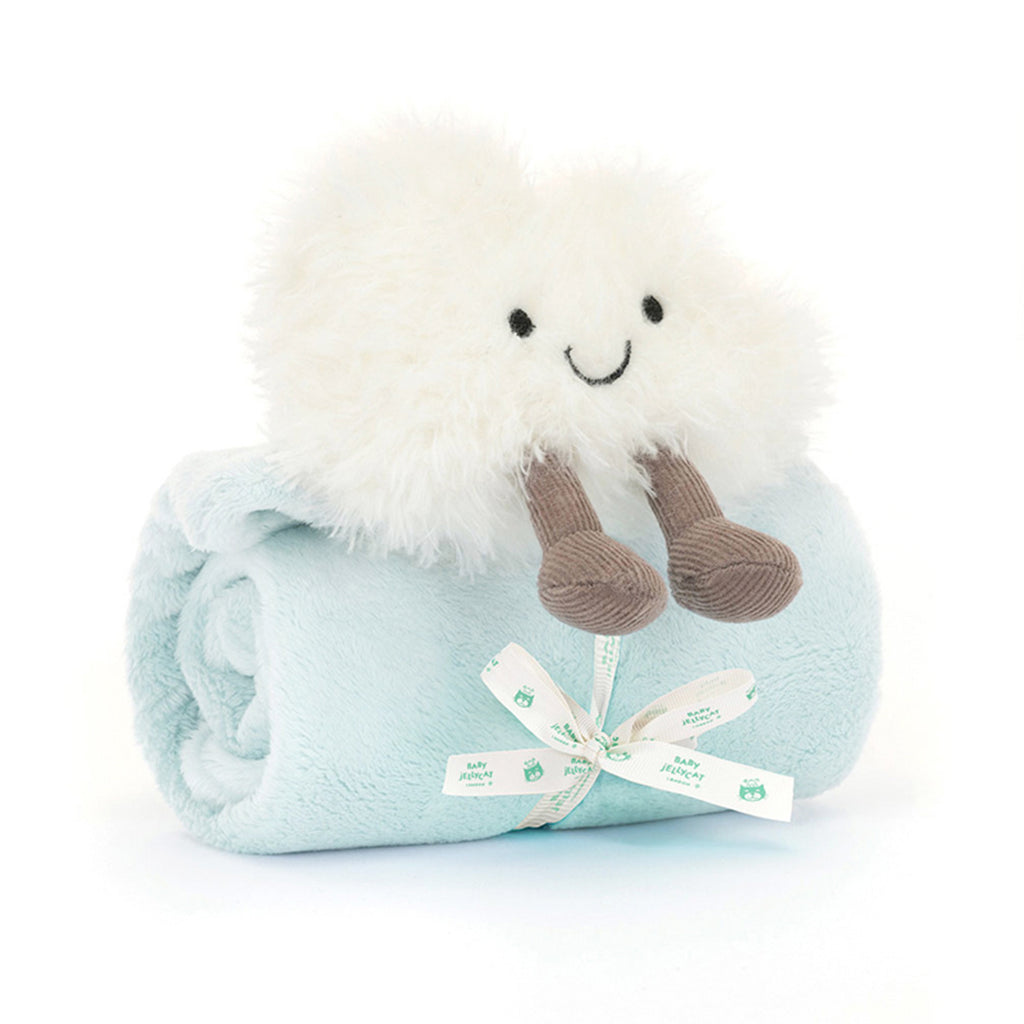 Plush toy with a white face and brown feet on a light blue blanket, on a white background