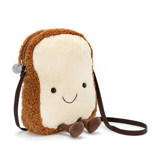 A plush toy resembling a slice of toast with a smiling face, complete with a cross-body strap.