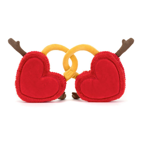 Two plush toy hearts locks with red fur, cord and embroidered accents, connected by a golden yellow lock part.
