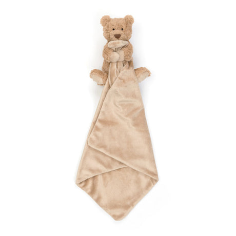 A plush toy bear holding a square-shaped soother, 
