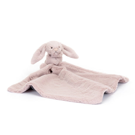 Pink plush bunny with blanket on a white background