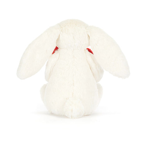 A plush toy of a white bunny holding a red love heart.