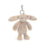 Fluffy beige bunny keychain with floral ears on a white background