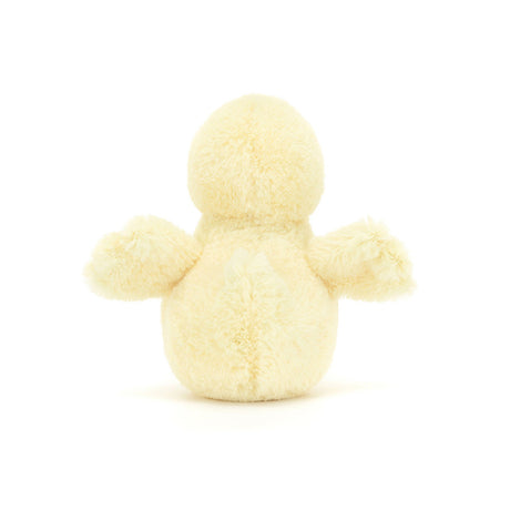 A plush toy representing a pastel yellow fluffy duck with a orange bill and raised tail, waving its wings.