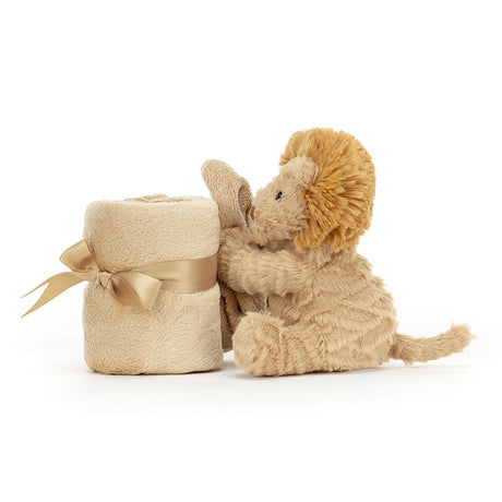 A plush toy depicting a lion with a beige mane and cream-brûlé fur, holding and cuddling a beige soother blanket