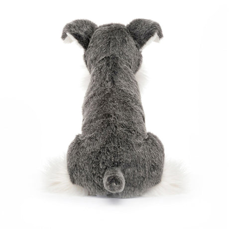 Plush toy dog with gray and white fur on a white background