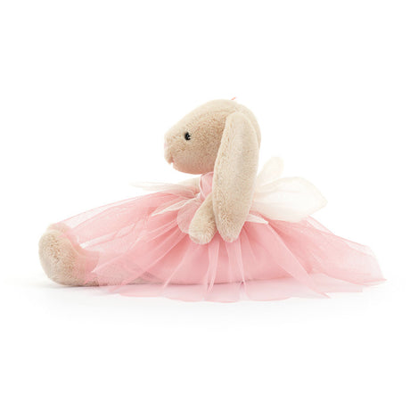 A plush toy resembling a beige bunny with pink ballet attire, including a tutu and bow, sitting against a white background.
