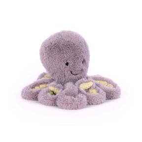 A plush toy resembling a mauve octopus with embroidered features and soft texture.