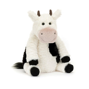 Plush jellycat soft cow toy on a white background