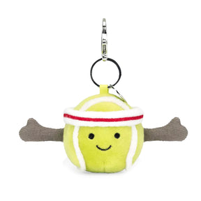 A plush toy in the shape of a yellow tennis ball with red and white details, wearing a white and red headband, attached to a silver clip and chain.