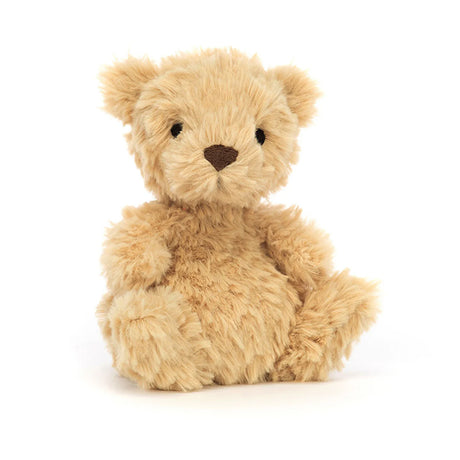 A small, plush, brown teddy bear with a tuft of honey-colored fur, embroidered eyes, and a cocoa-colored nose.