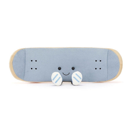 A plush toy in the shape of a skateboard with a smiling face. It has blue fabric with beige edging and orange details.